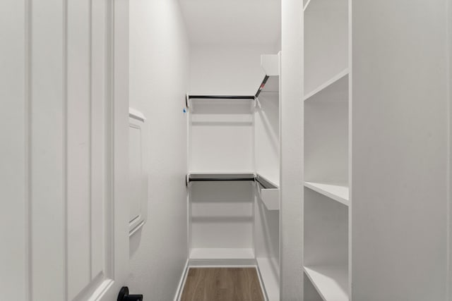 spacious closet featuring hardwood / wood-style floors