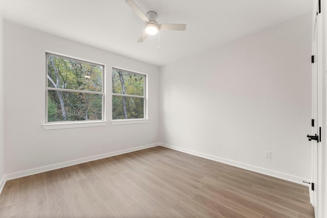 empty room featuring ceiling fan and hardwood / wood-style flooring