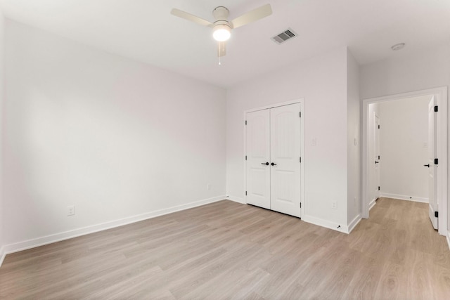 unfurnished bedroom with ceiling fan, a closet, and light hardwood / wood-style floors