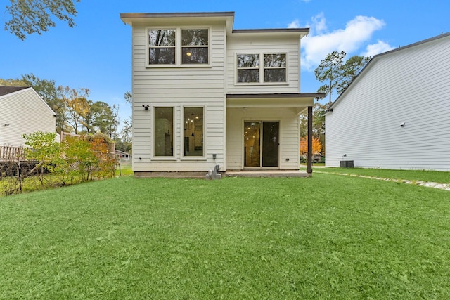 back of house featuring cooling unit and a yard