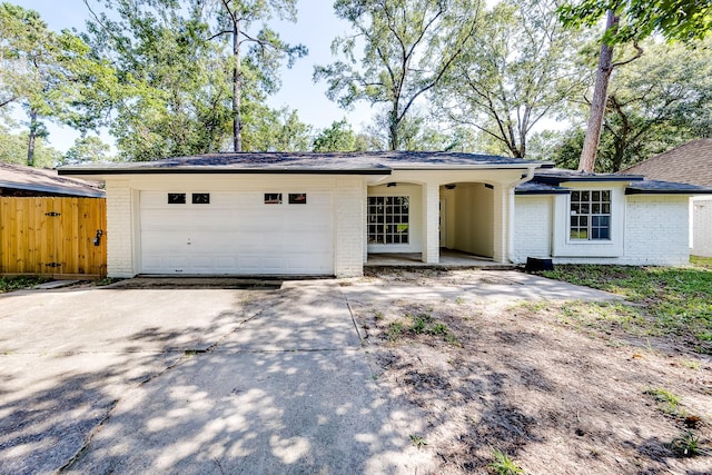 ranch-style home featuring a garage