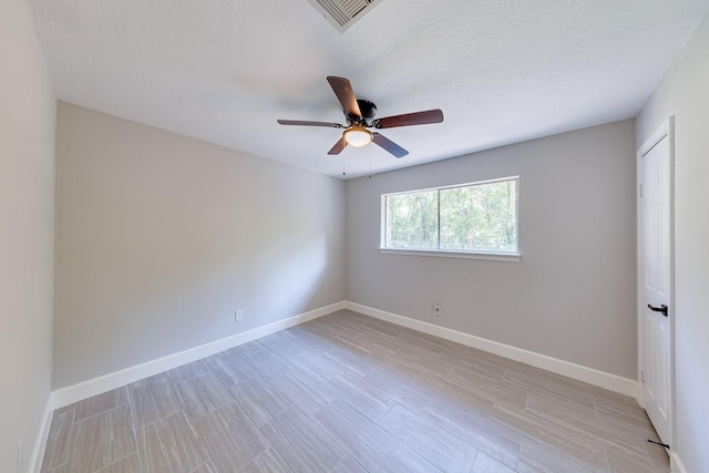 unfurnished room with a textured ceiling and ceiling fan