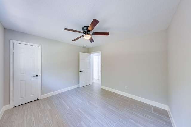 empty room featuring a textured ceiling and ceiling fan