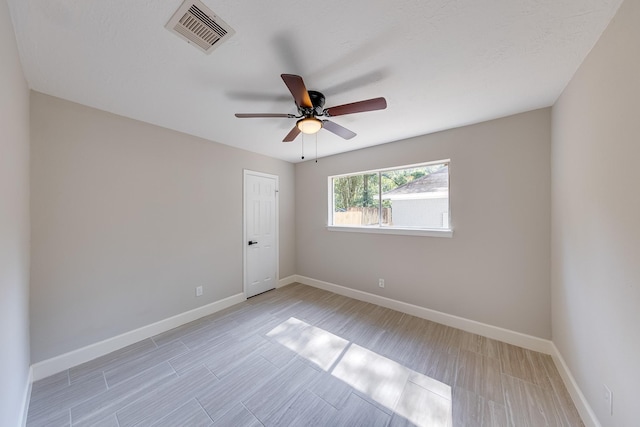 empty room featuring ceiling fan