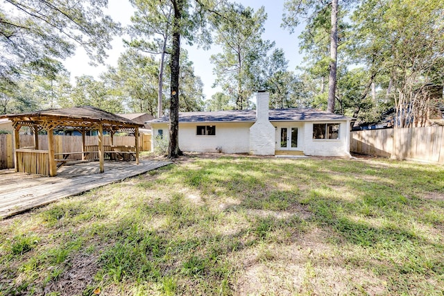 exterior space with a gazebo, french doors, and a wooden deck