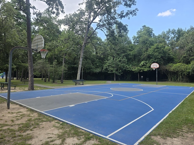 view of sport court featuring a yard