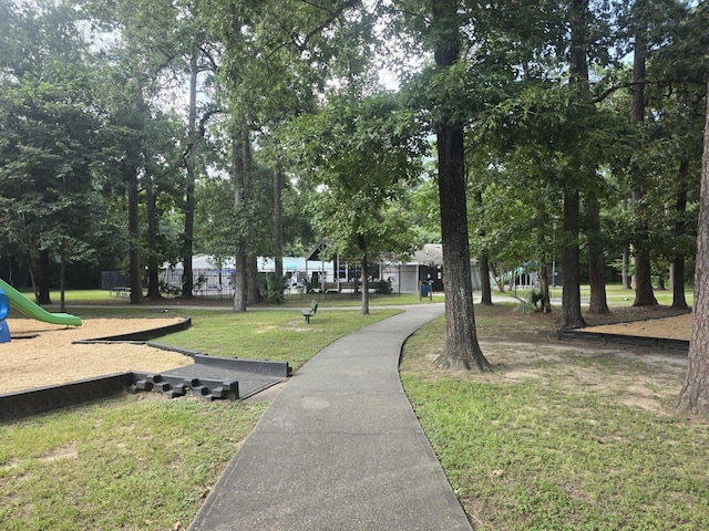 view of property's community featuring a playground and a yard