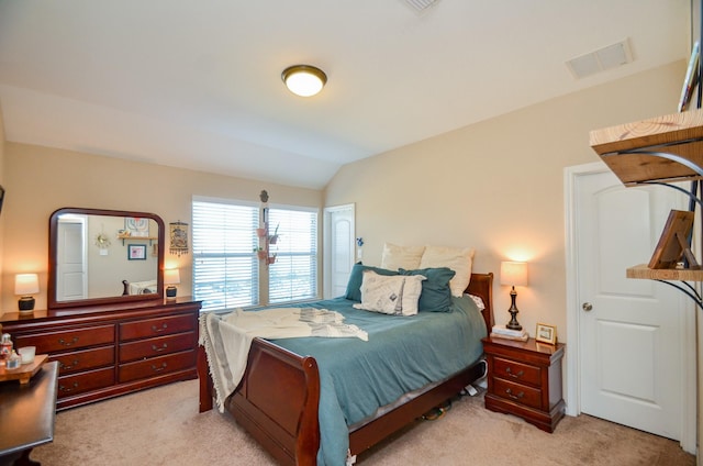 bedroom featuring light carpet and lofted ceiling