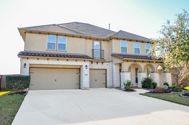 mediterranean / spanish-style house with a garage