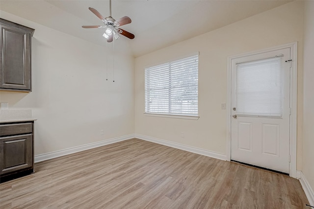 unfurnished dining area with light hardwood / wood-style floors and ceiling fan