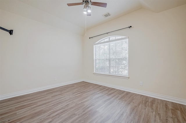 spare room with lofted ceiling, light hardwood / wood-style flooring, and ceiling fan