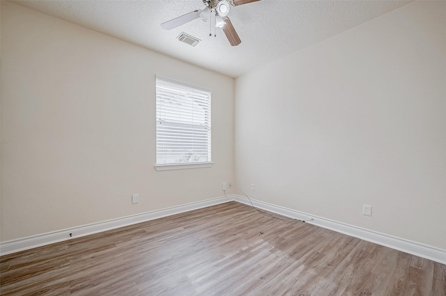 unfurnished room with a textured ceiling, light hardwood / wood-style floors, and ceiling fan