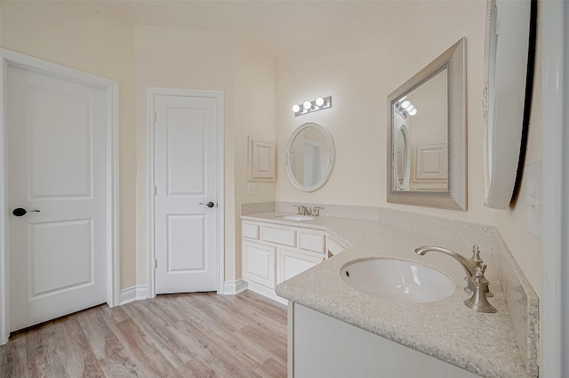 bathroom with vanity and hardwood / wood-style floors