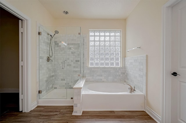 bathroom featuring separate shower and tub and hardwood / wood-style floors