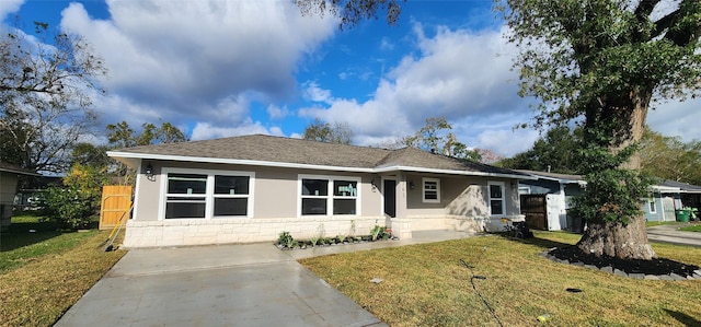 ranch-style home with a front lawn