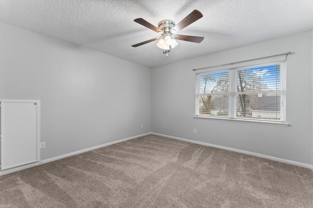 carpeted empty room featuring a textured ceiling and ceiling fan