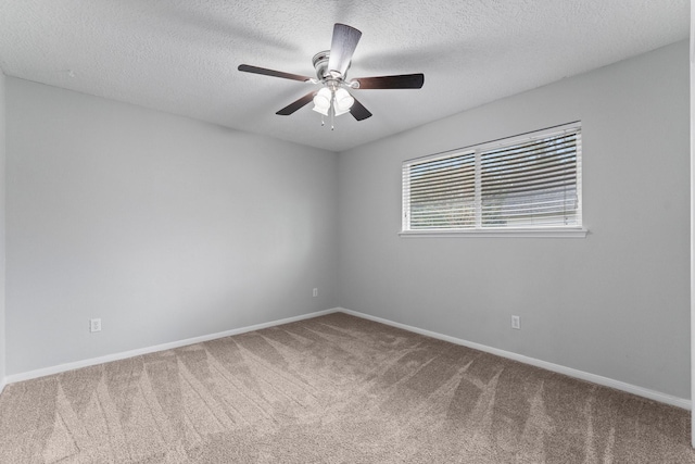 carpeted empty room featuring a textured ceiling and ceiling fan