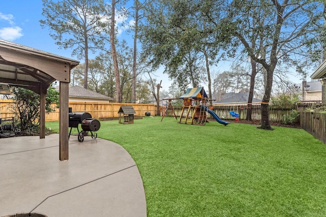 view of yard featuring a playground and a patio area