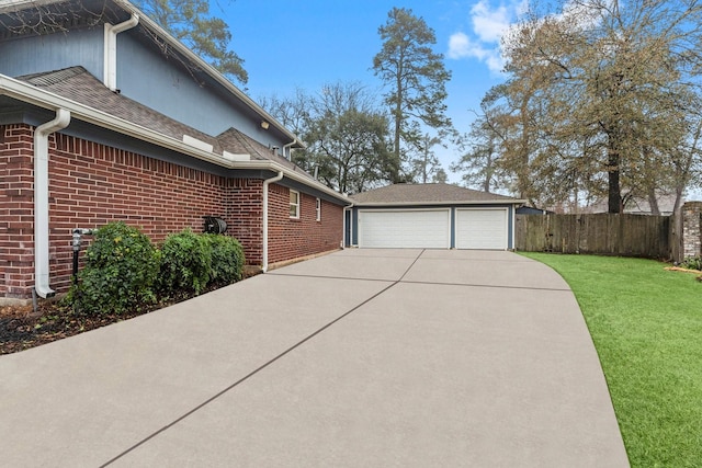 view of side of property with a garage and a lawn