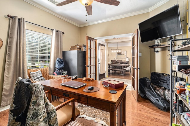 office area with light wood-type flooring, ceiling fan, french doors, and ornamental molding