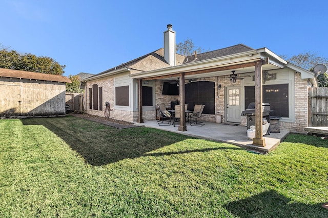 rear view of house with a yard, a patio, and ceiling fan