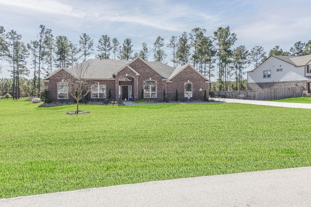 ranch-style house featuring a front lawn