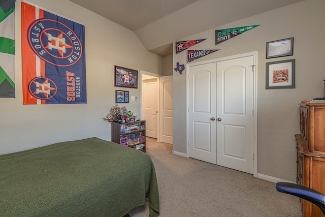 bedroom featuring vaulted ceiling, carpet floors, and a closet