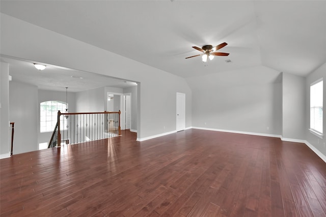 spare room with ceiling fan, vaulted ceiling, and dark hardwood / wood-style floors