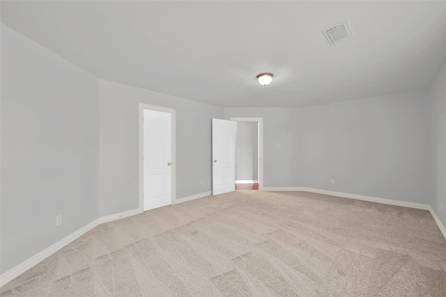 unfurnished room with light colored carpet