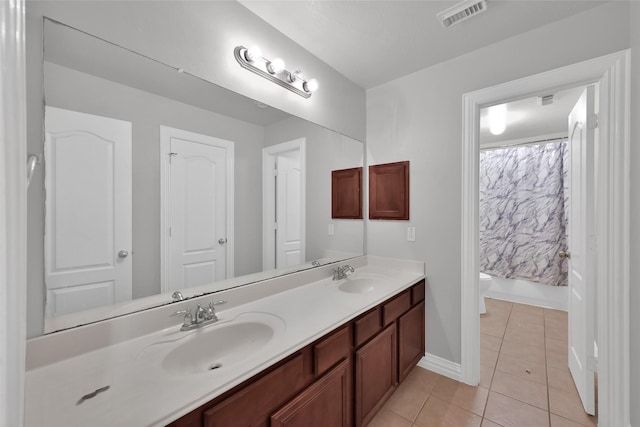 full bathroom featuring toilet, vanity, tile patterned flooring, and shower / tub combo