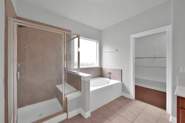 bathroom with plus walk in shower and tile patterned flooring