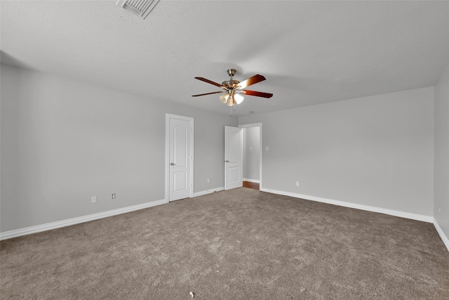 unfurnished bedroom with ceiling fan and dark carpet