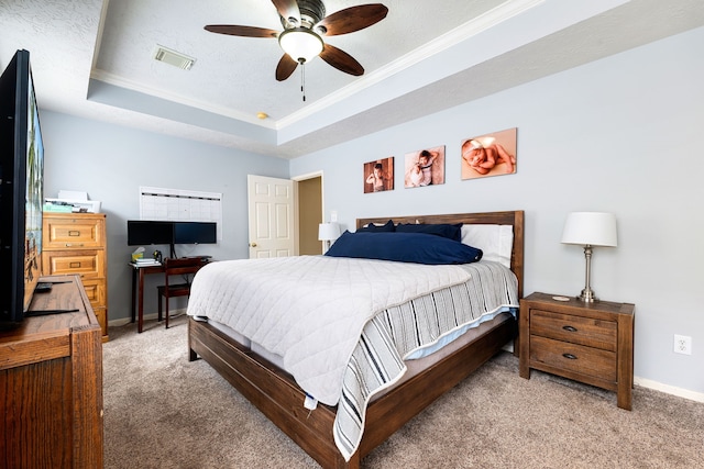 carpeted bedroom featuring ceiling fan, ornamental molding, and a raised ceiling