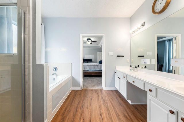 bathroom featuring wood-type flooring, vanity, a textured ceiling, and a healthy amount of sunlight