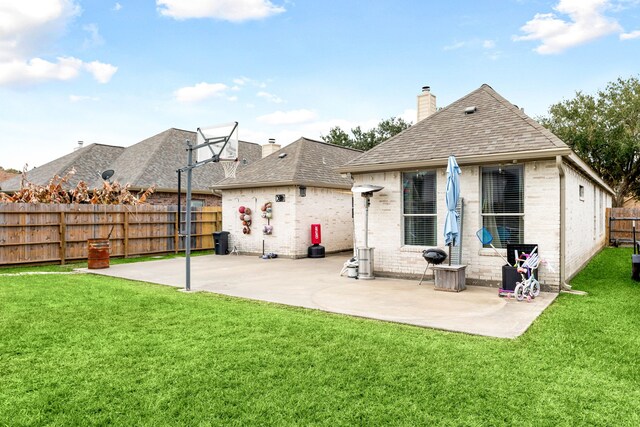 rear view of property featuring a yard and a patio