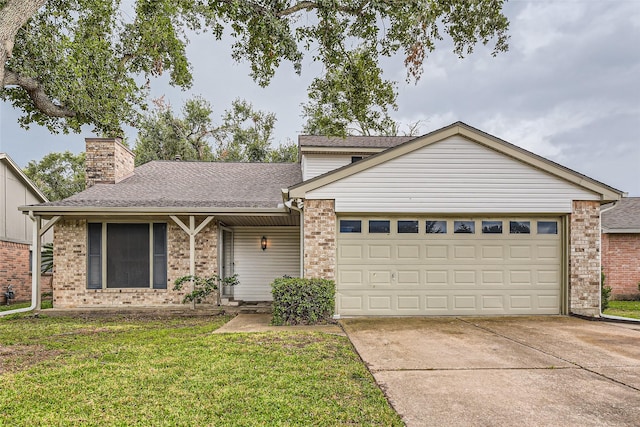 view of front of property with a front lawn and a garage