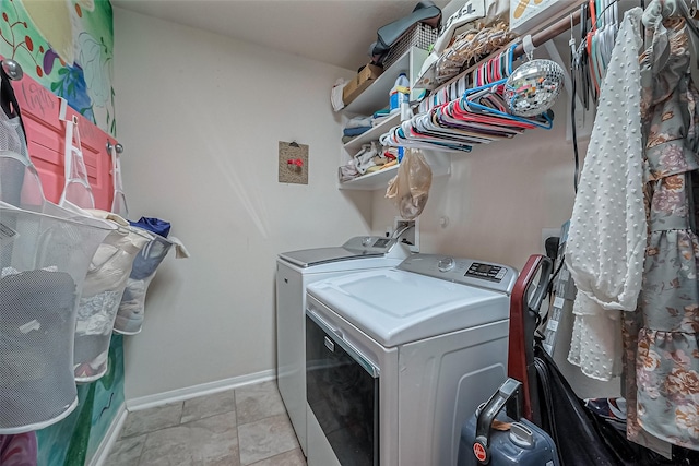 clothes washing area featuring separate washer and dryer and light tile patterned flooring