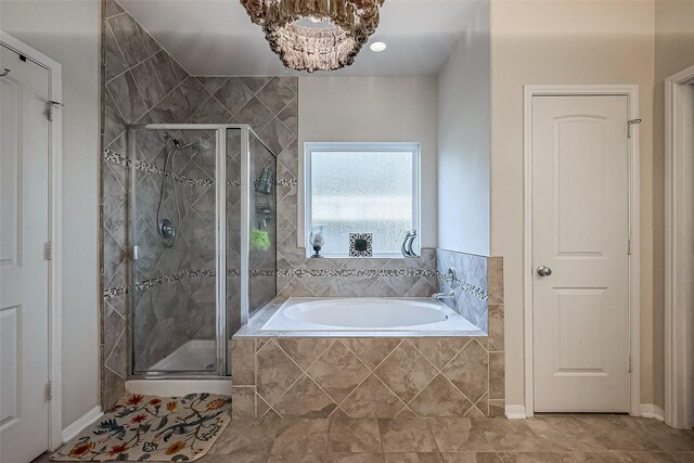 bathroom featuring tile patterned flooring and separate shower and tub