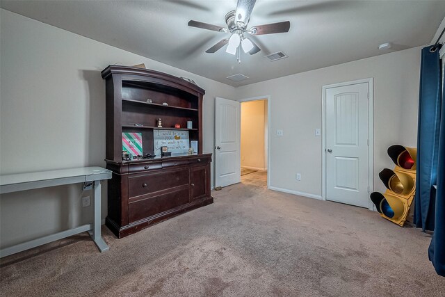 interior space featuring light colored carpet and ceiling fan