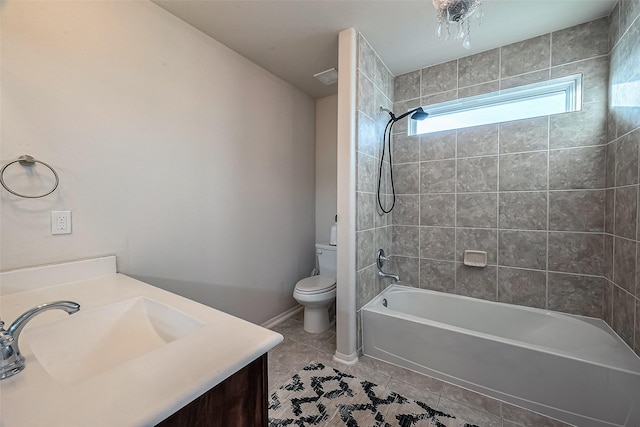 full bathroom with tiled shower / bath, tile patterned floors, toilet, and vanity