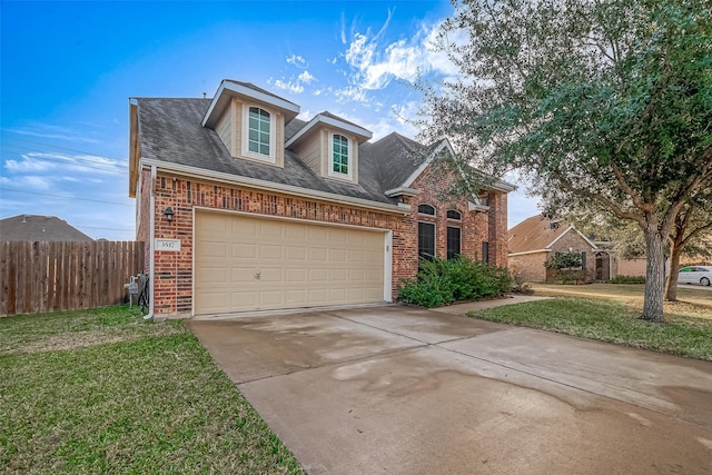 view of front of property featuring a garage and a front yard