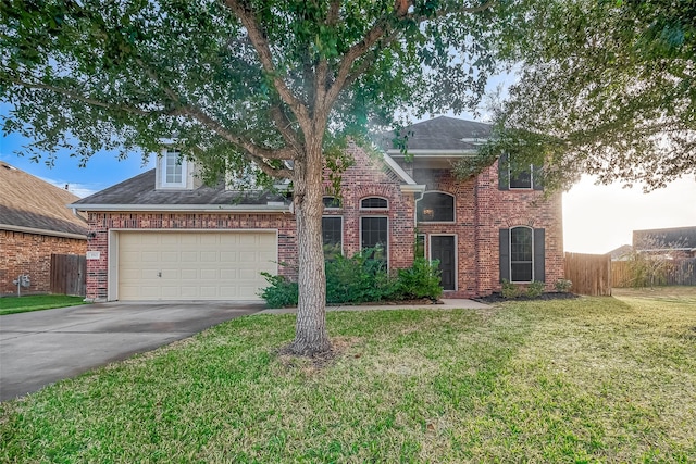 view of front of house with a garage and a front lawn