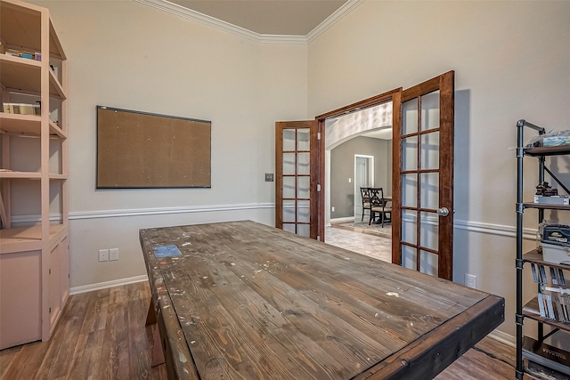 home office featuring ornamental molding, wood-type flooring, and french doors