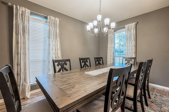 dining area featuring a notable chandelier and light hardwood / wood-style flooring