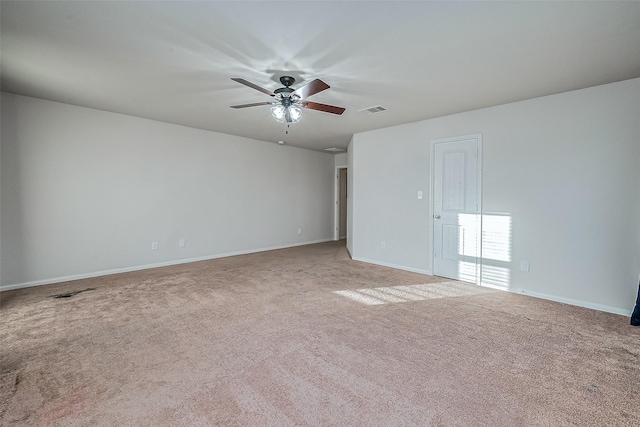 carpeted spare room featuring ceiling fan