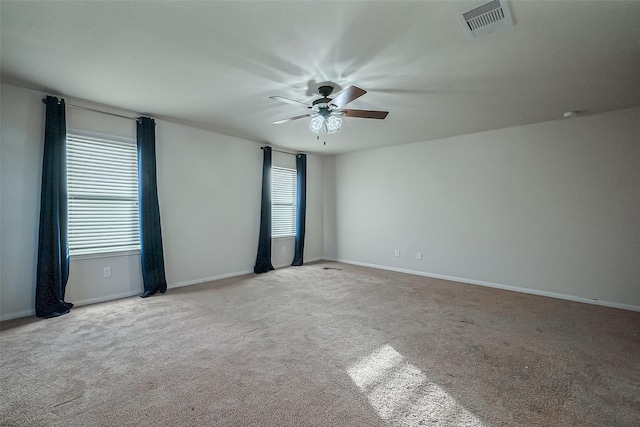 carpeted spare room with ceiling fan