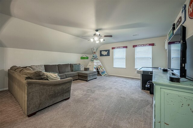 carpeted living room featuring ceiling fan and vaulted ceiling