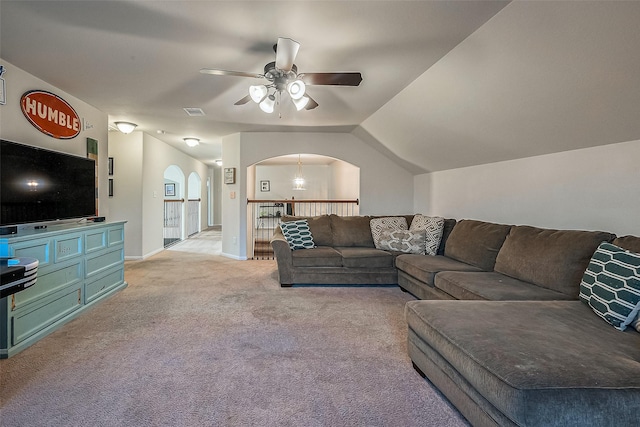 living room with vaulted ceiling, light colored carpet, and ceiling fan