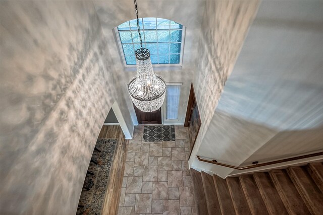 entryway featuring a notable chandelier and a towering ceiling