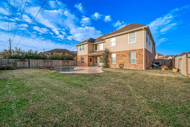 rear view of property featuring a yard and a patio